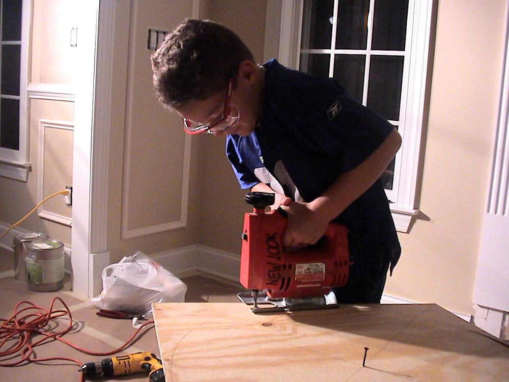 kid using electrical saw